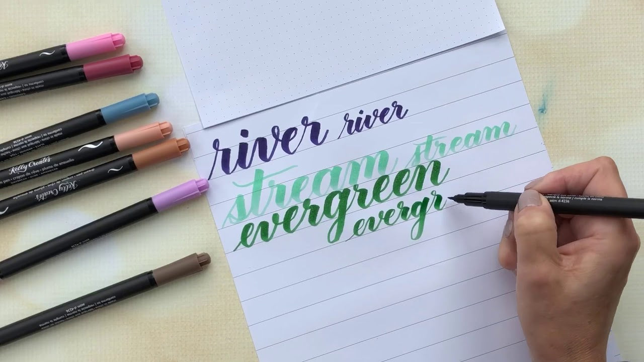 Load video: Watch Kelly swatch out all the pretty new colors of the new “Meadow” Dream pens by writing their names in brush lettering.