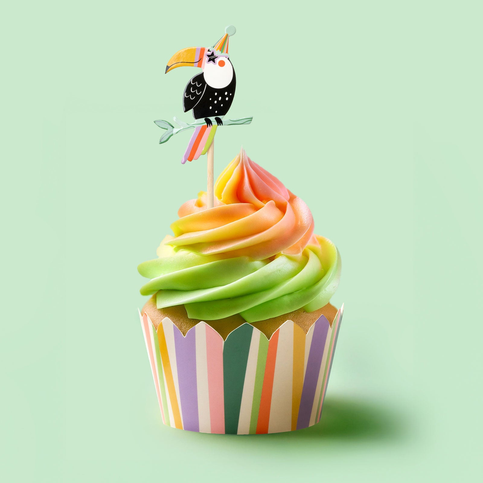 Cupcake with parrot cake topper and colorful cupcake wrapper