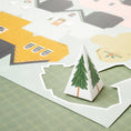 Load image into Gallery viewer, A piece of the Crate Paper Holly Jolly Holiday Village 12 x 12 Cardstock Specialty Paper - 15 Pack that is folded
