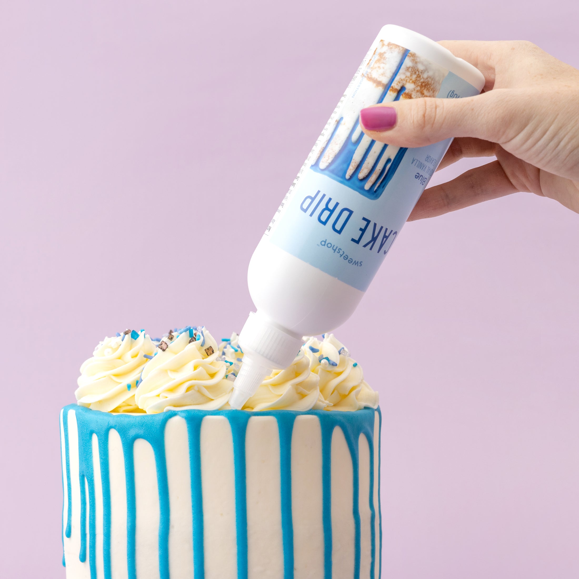 Lifestyle of blue Sweetshop Cake Drip being used on white cake