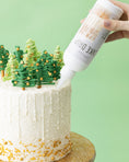 Load image into Gallery viewer, Lifestyle image of white Sweetshop Cake Drip being used on a Christmas themed cake
