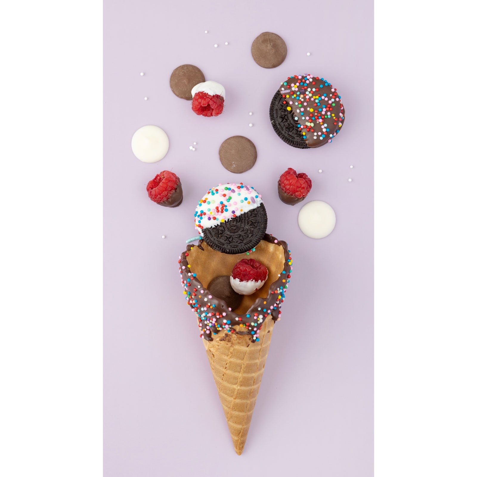 Lifestyle image of an assortment of chocolate dipped treats with ice cream cone