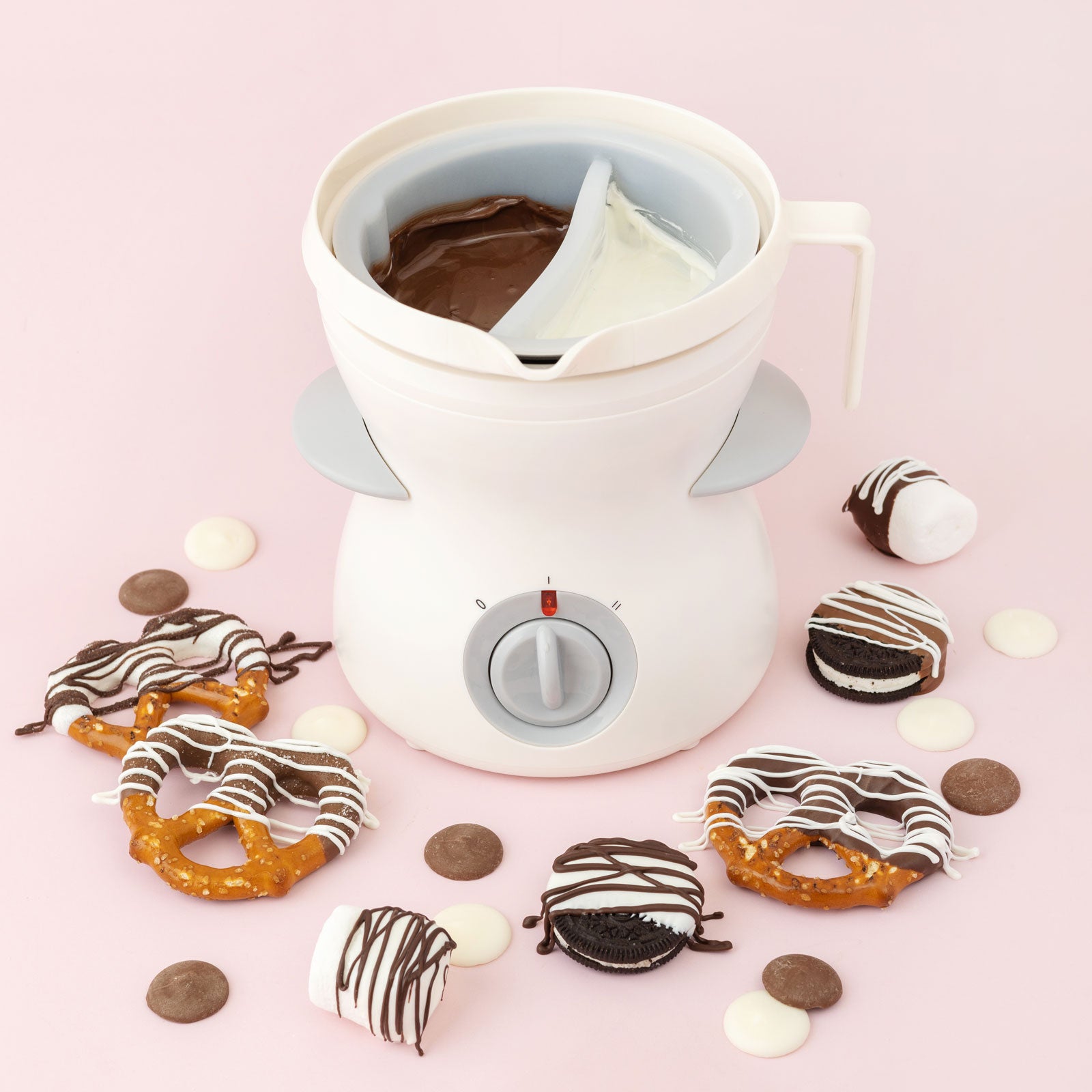 Lifestyle image of AC Sweetshop Dual Chocolate Melting Pot with an assortment of chocolate dipped pretzels and oreos