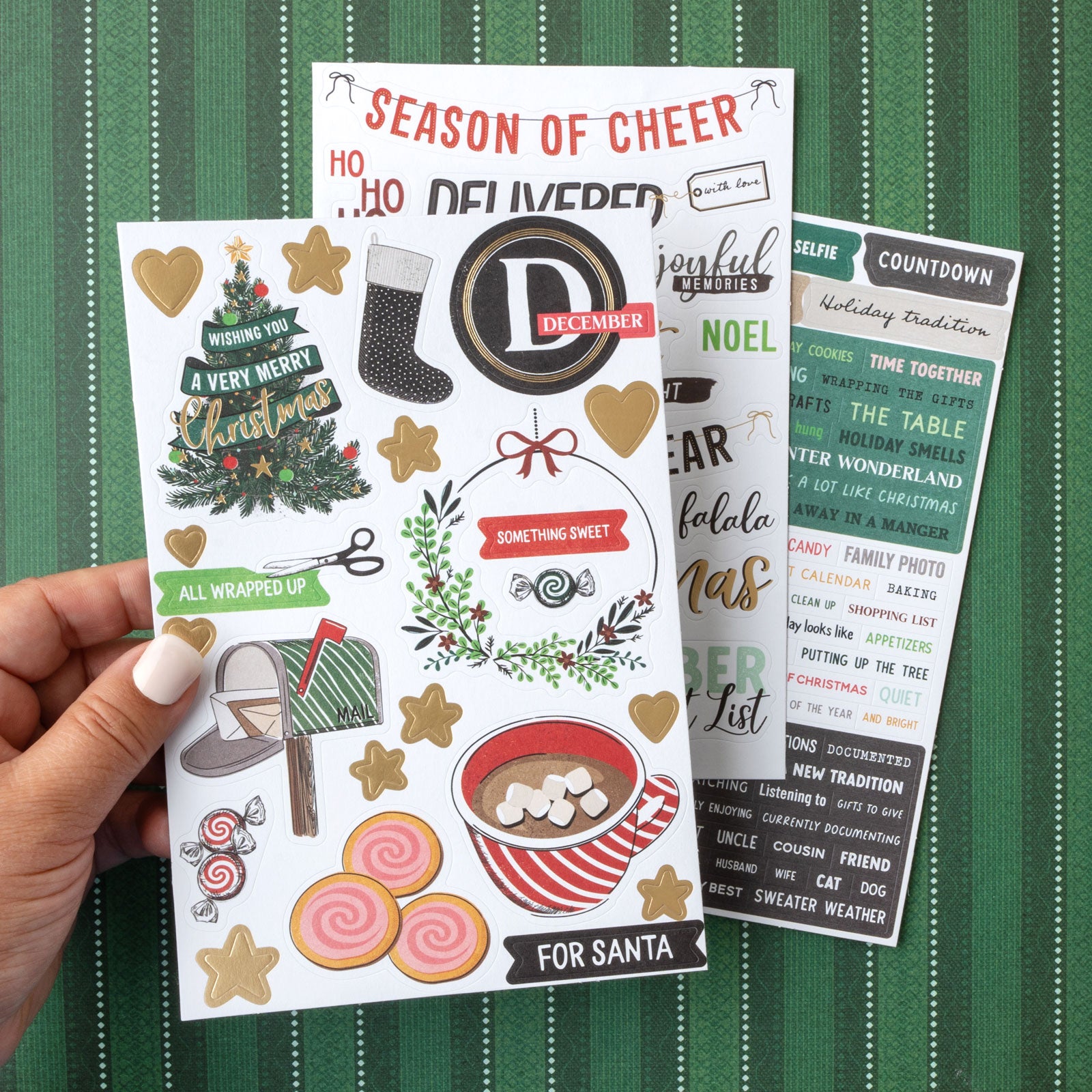 Lifestyle image of three sheets of stickers from American Crafts Vicki Boutin Wrapped in Ribbons Sticker Book - 262 Piece