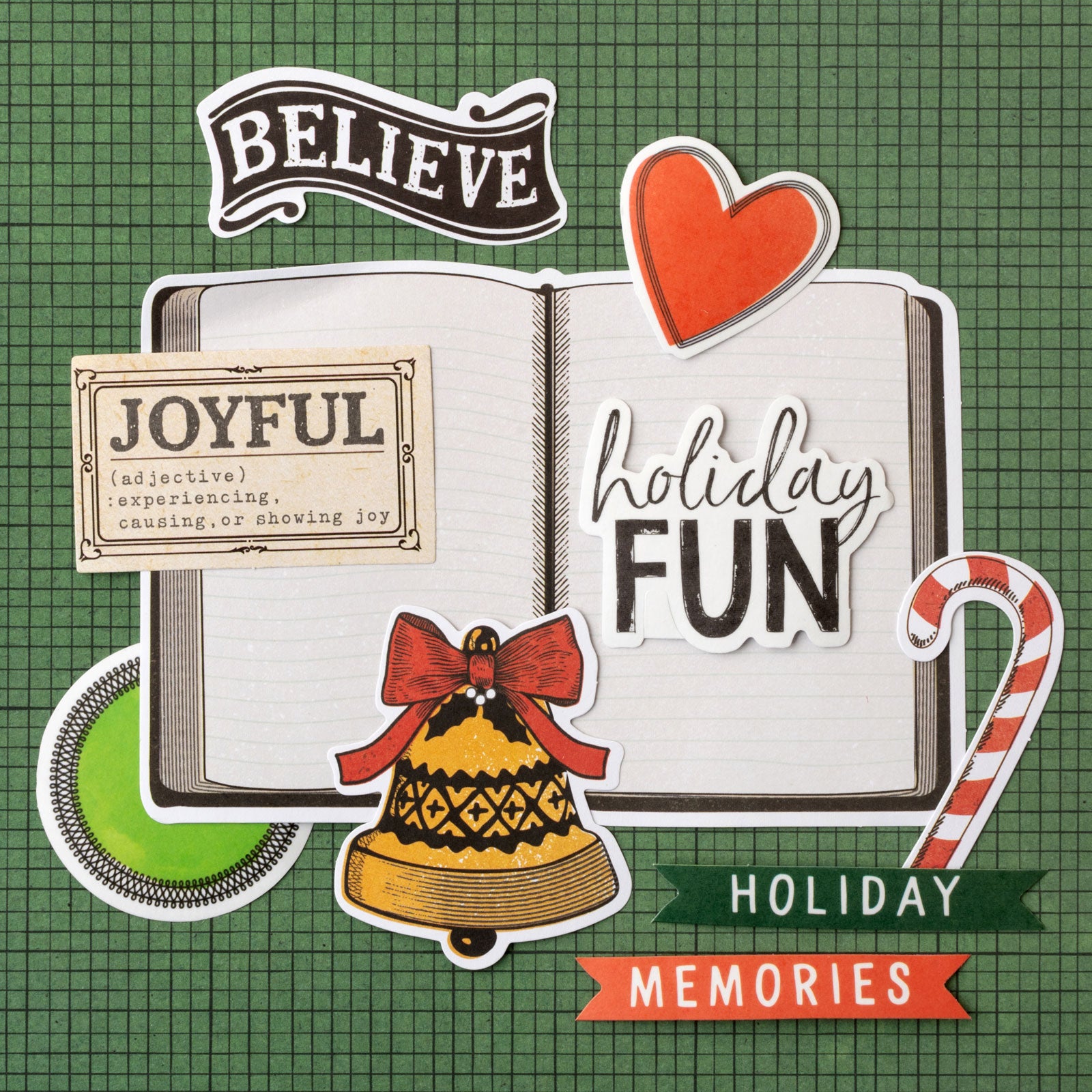 Lifestyle image of a few pieces from the American Crafts Vicki Boutin Wrapped in Ribbons Paperie Pack - 200 Piece on green background