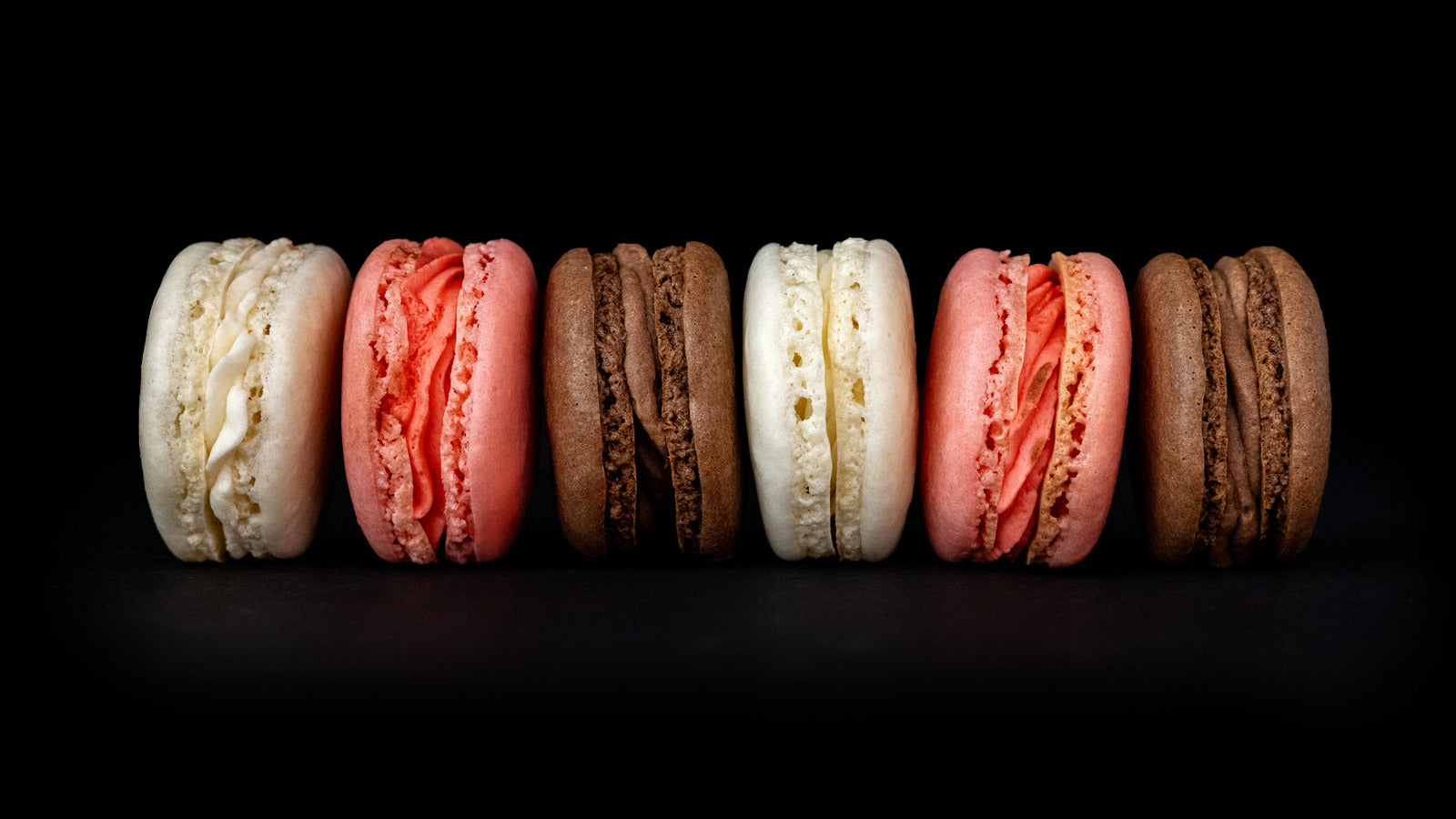 Lifestyle image of three flavors of macarons in a row