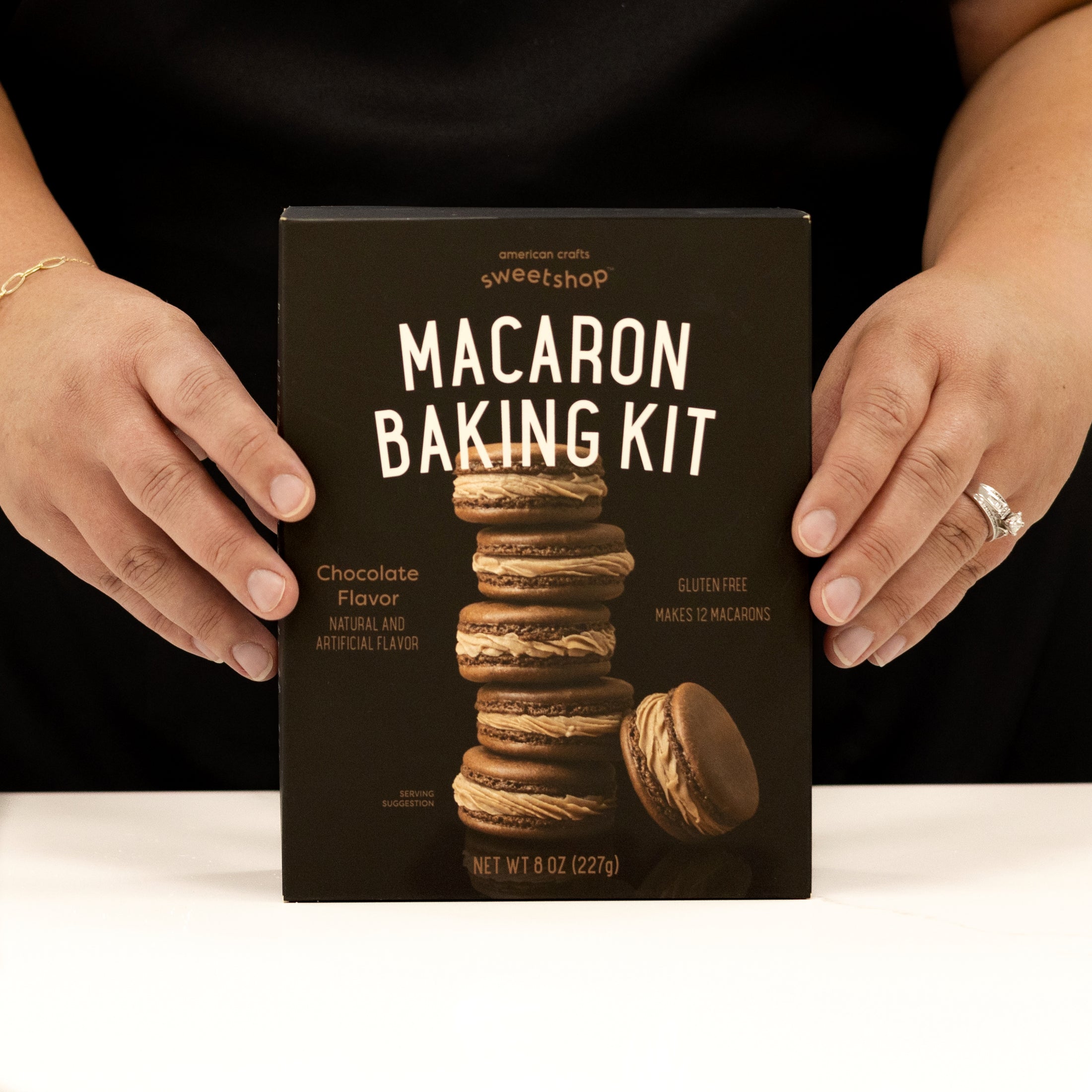 Person holding Sweetshop Chocolate Gluten Free Macaron Baking Kit package