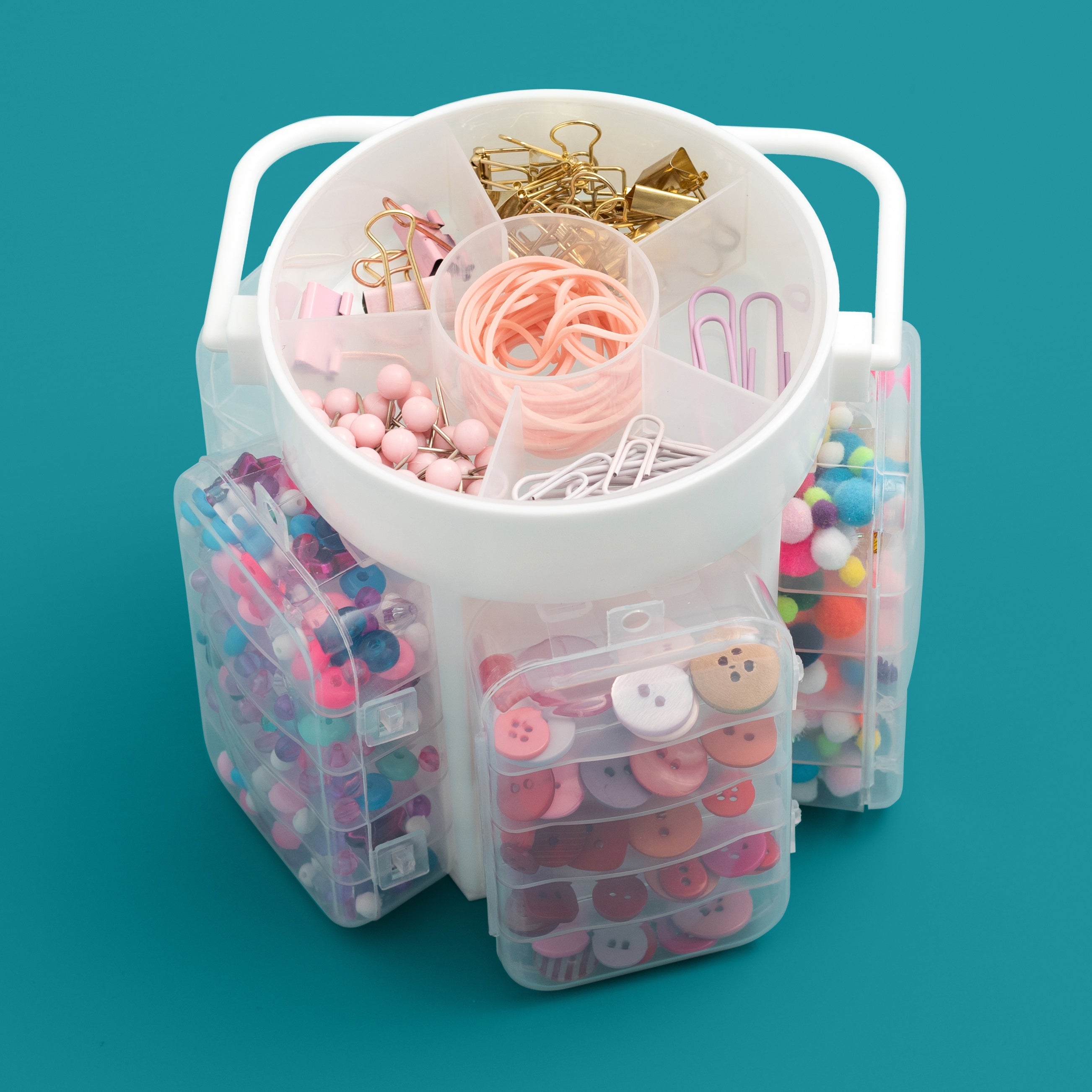 Clear organizer with compartments filled with colorful stationery items on a teal background