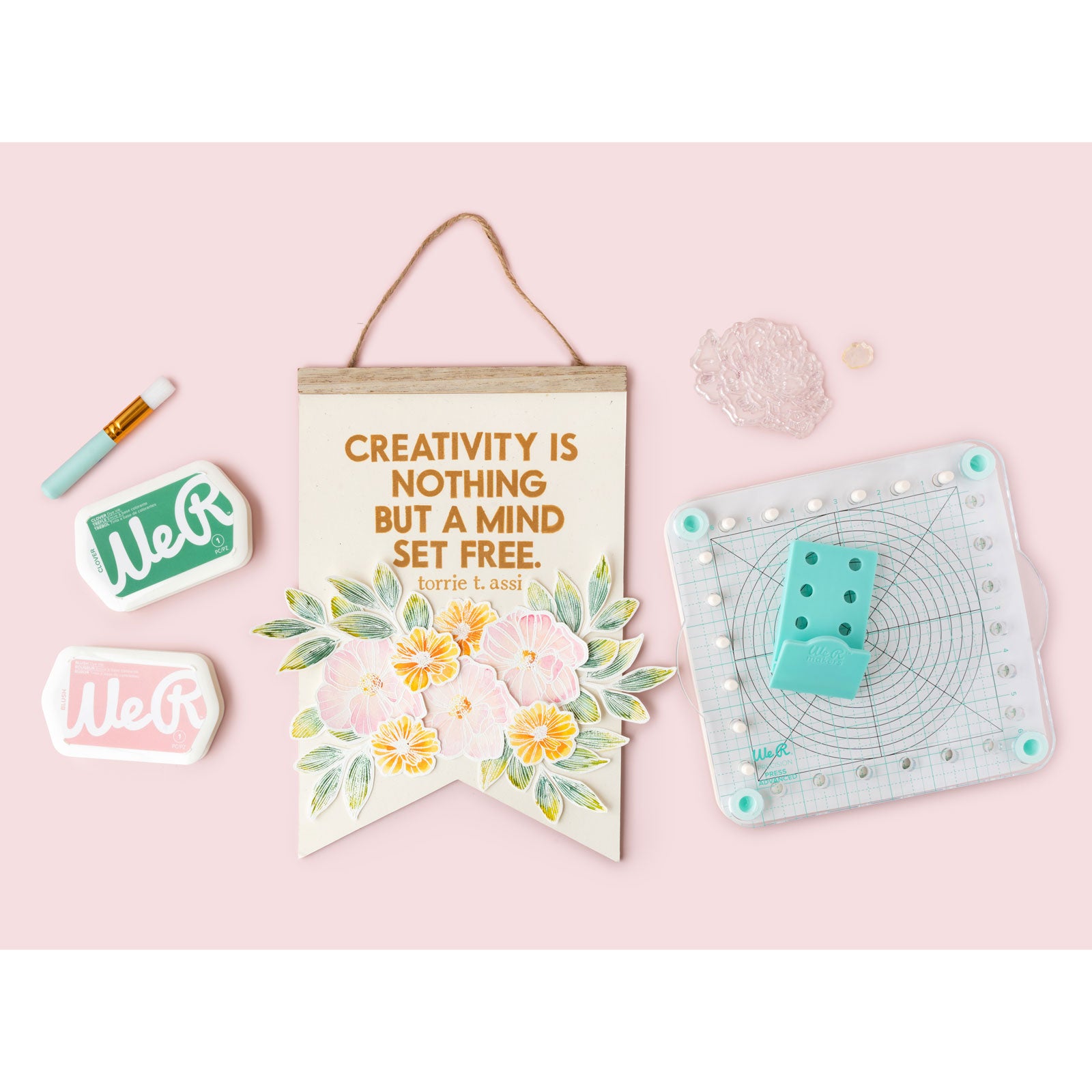 Lifestyle image with banner craft with the We R Makers Precision Press Stamp and Stencil Holder Bundle