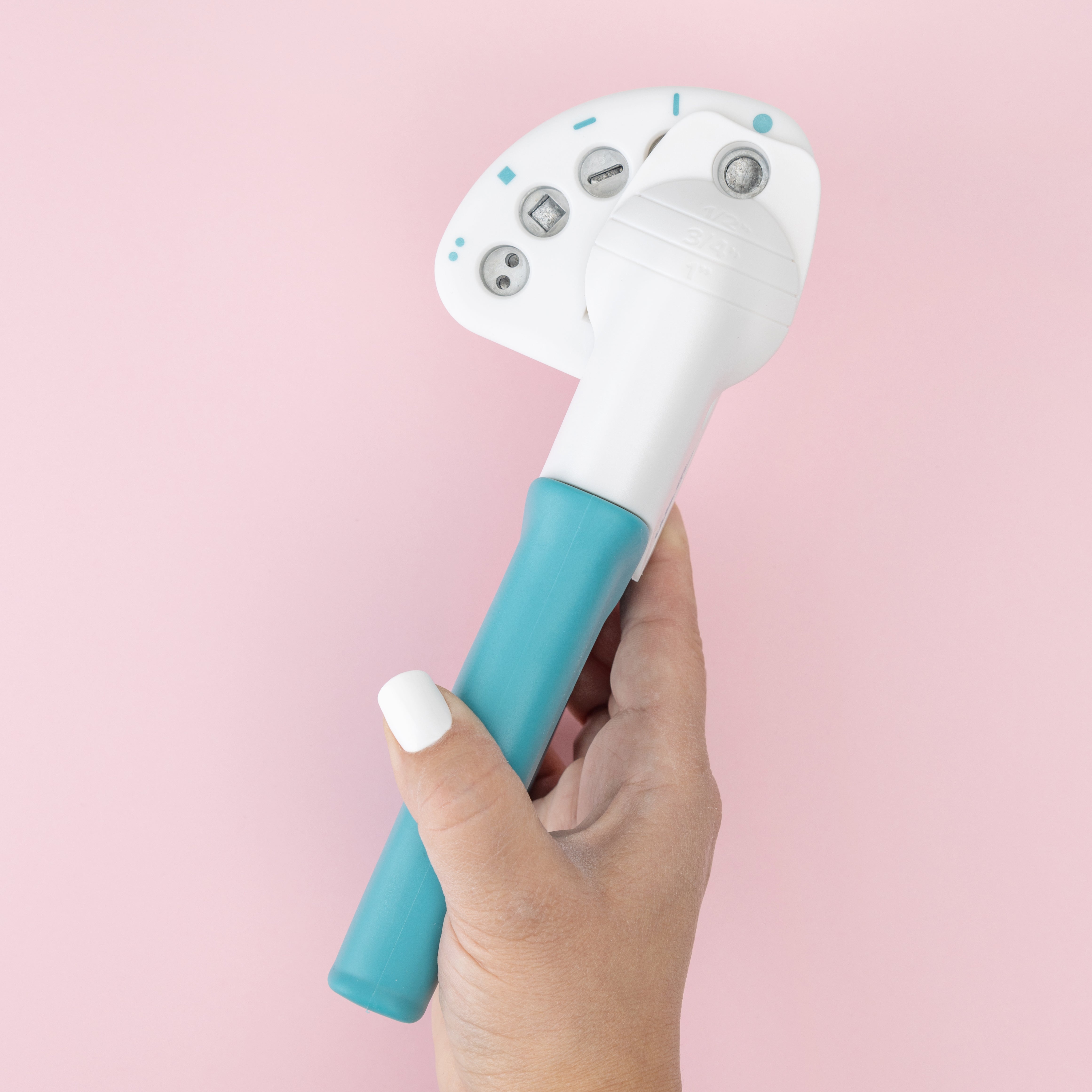 We R Makers Crop-A-Dile Functional Multi Hole Power Punch being held to show size