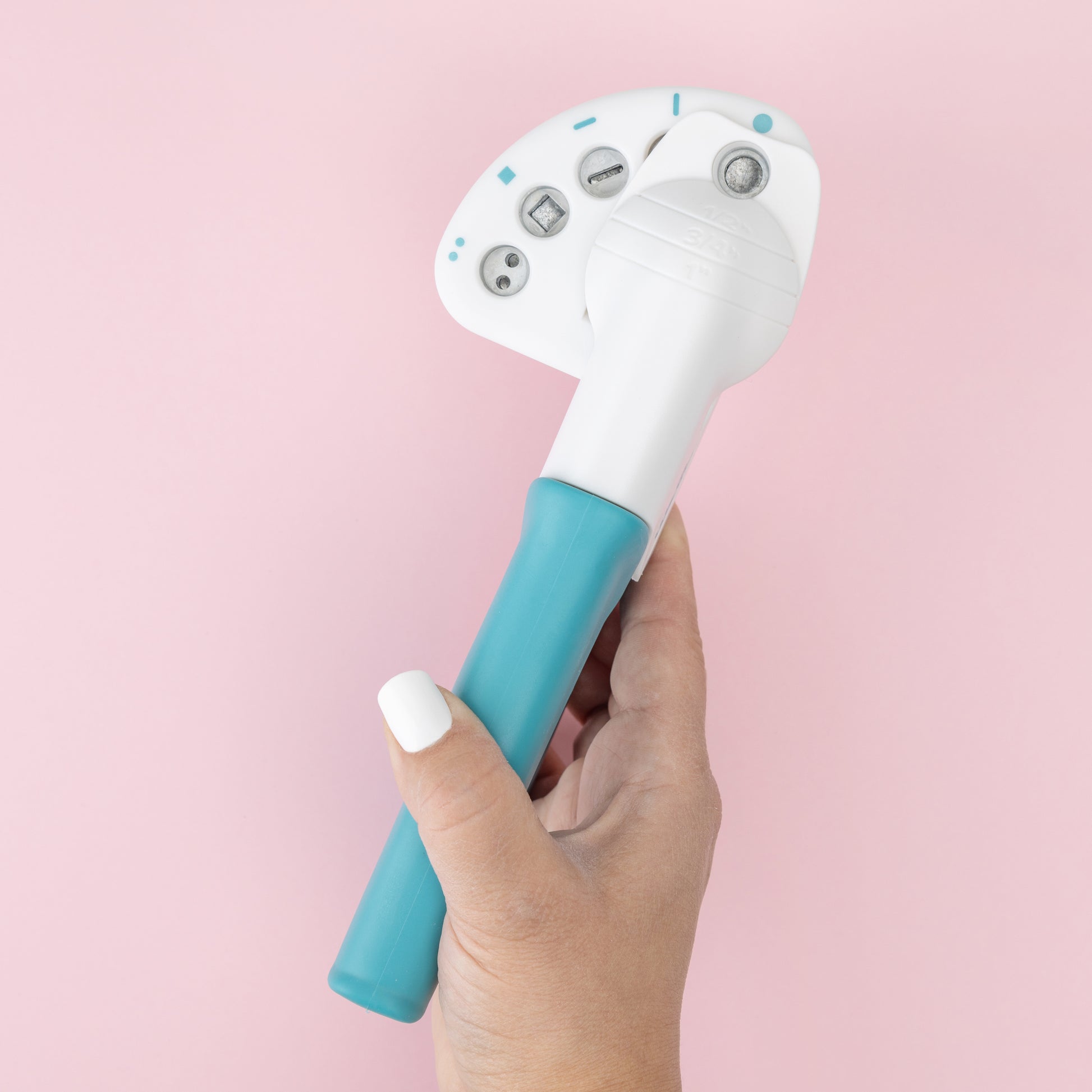 We R Makers Crop-A-Dile Functional Multi Hole Power Punch being held to show size