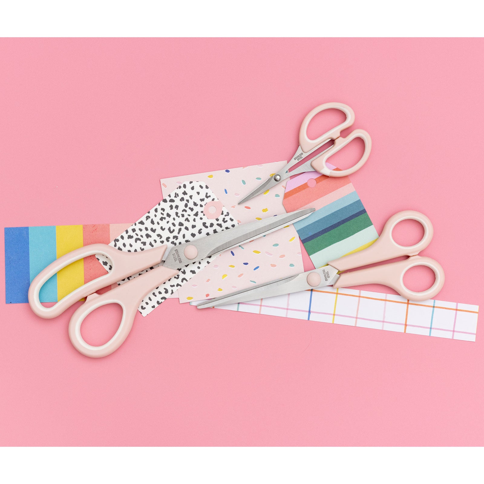 Lifestyle images of We R Makers Pink Craft Scissors - 3 Pack with craft paper