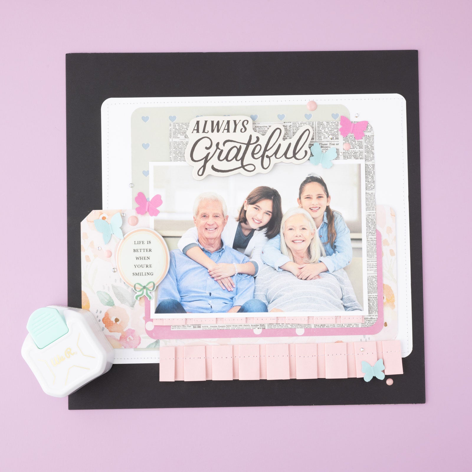 Paper crafts that has corners punched with the We R Makers 3-Way Diagonal Paper Punch on purple background