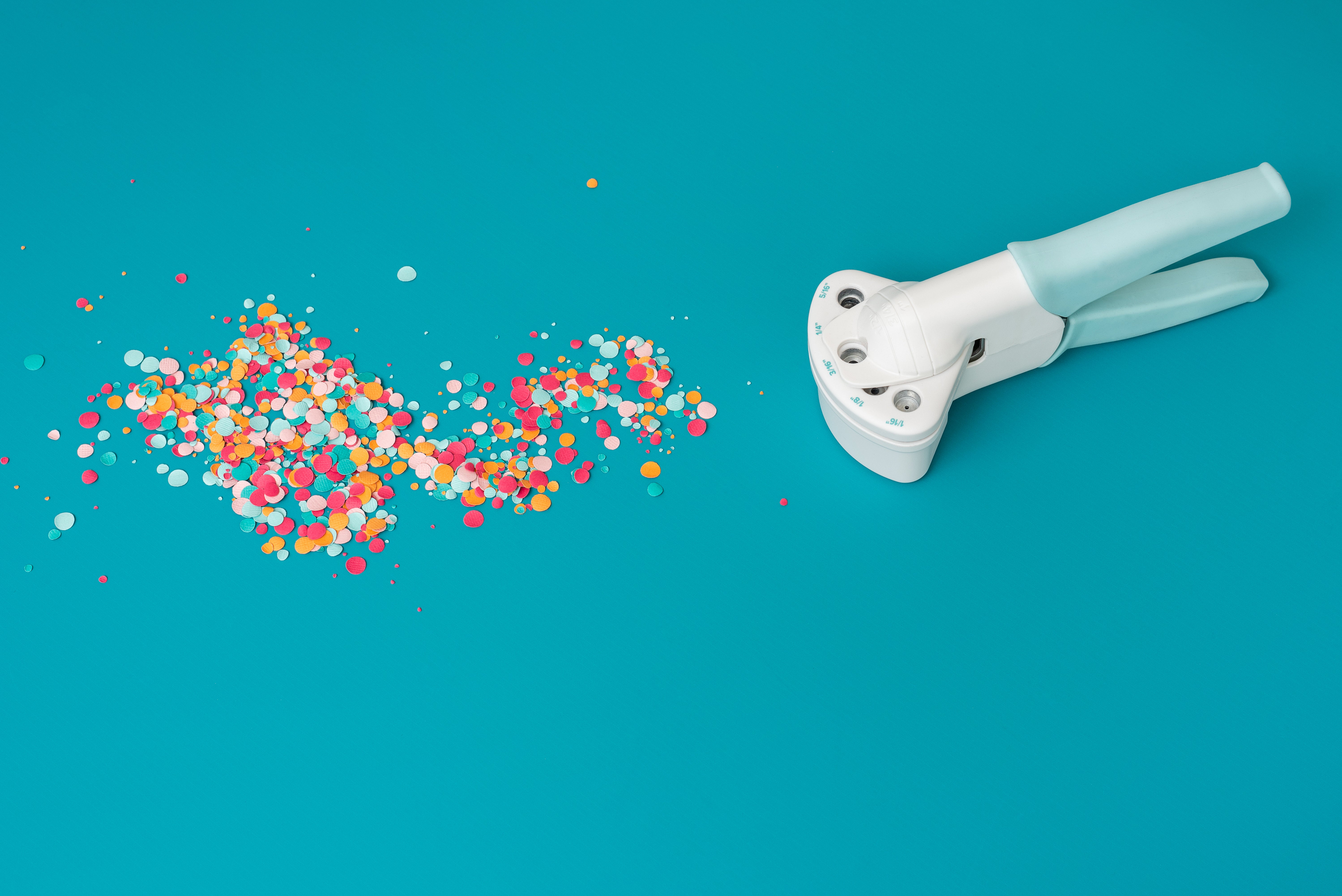 We R Makers Crop-A-Dile Circle Multi Hole Punch with circle cut outs of paper