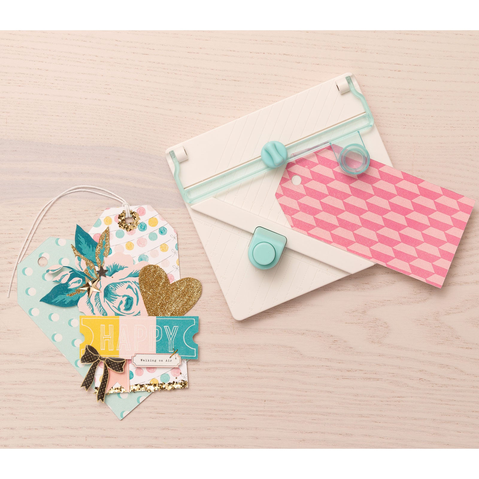 Lifestyle image of We R Makers Tag Punch Board with an assortment of tags