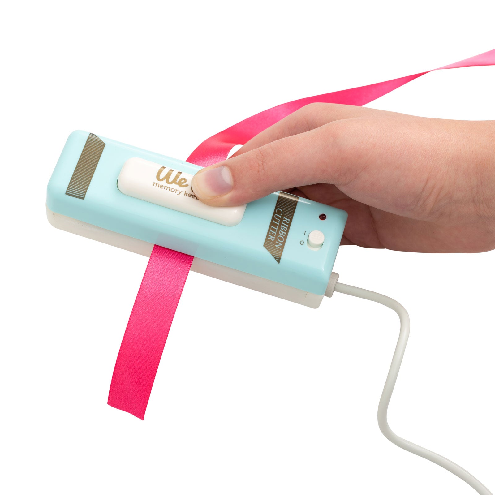 We R Makers USB Ribbon Cutter being used with pink ribbon
