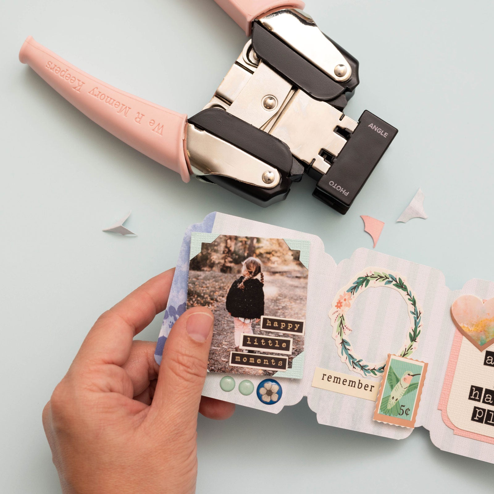 Lifestyle image of the We R Makers Crop-A-Dile Angle & Photo Corner Chomper Punch and craft with punched corners