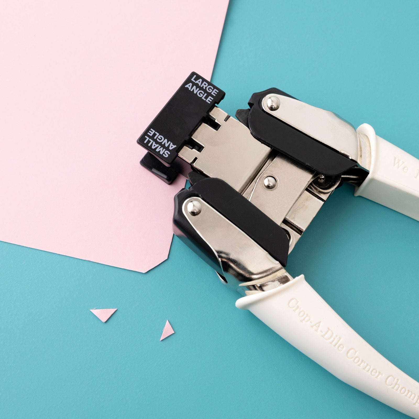 Lifestyle image of We R Makers Crop-A-Dile Small & Large Angle Corner Chomper Punch being used on corner on craft paper