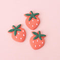 Load image into Gallery viewer, Three Sweetshop Strawberry Icing Decorations on pink background
