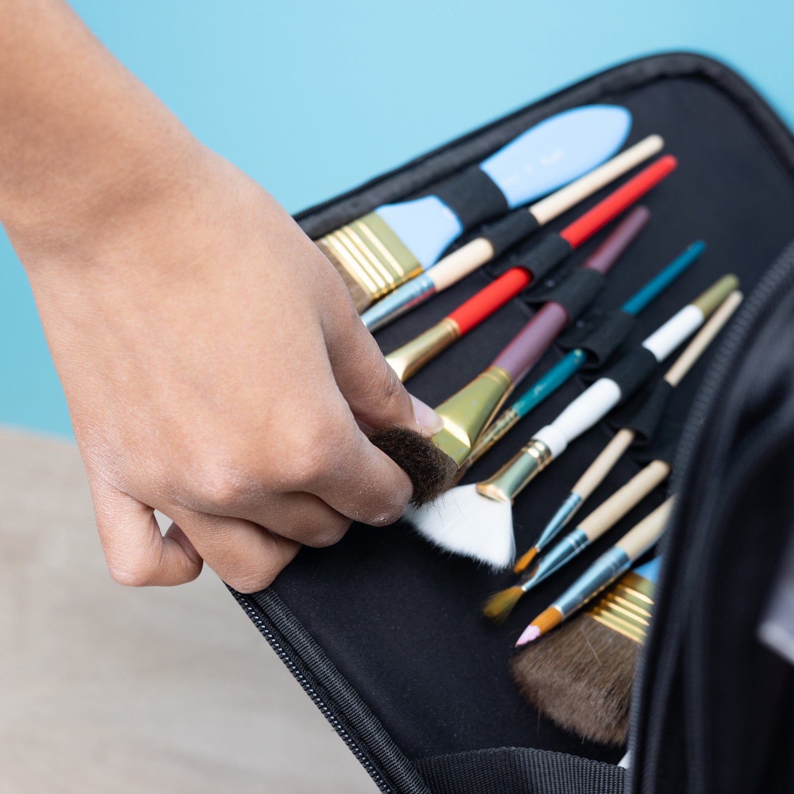 Close up of paint brush holders in American Crafts Crop In Style XXL Rolling Tote Craft Bag