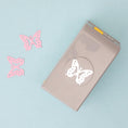 Load image into Gallery viewer, EK Tools Butterfly Laying Paper Punch with a few punched paper of butterfly shape
