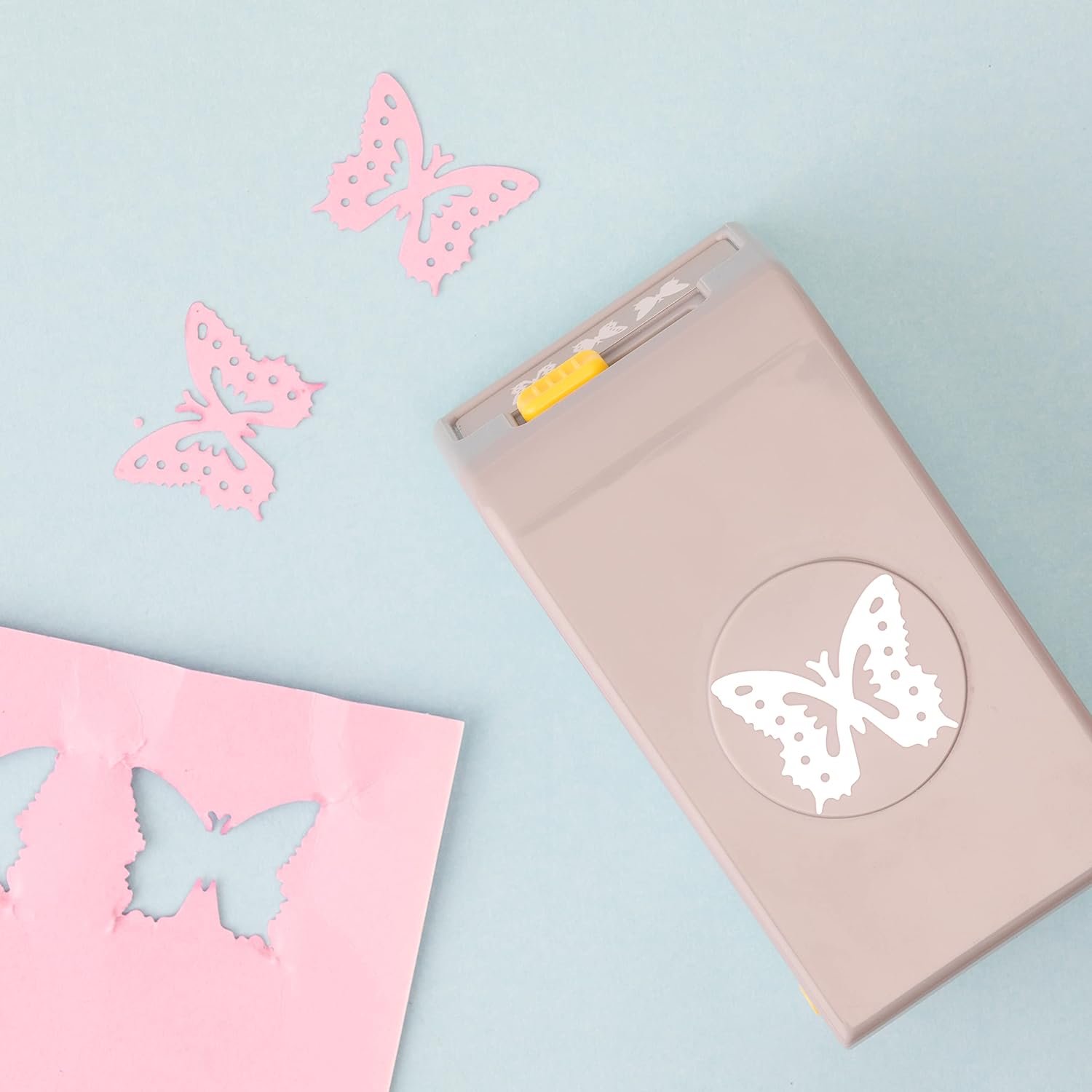 EK Tools Butterfly Laying Paper Punch with a few punched paper of butterfly shape