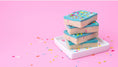 Load image into Gallery viewer, Lifestyle image of treats decorated with Sweetshop 10 oz Rainbow Parade Sprinkles Mix
