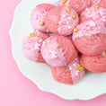 Load image into Gallery viewer, Lifestyle image of pink cookies decorating with Sweetshop 10 oz Unicorn Sprinkles Mix
