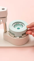 Load image into Gallery viewer, Picture of a hand grasping the We R Makers Button Press Kit.
