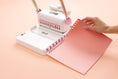 Load image into Gallery viewer, Lifestyle of We R Makers Cinch Book Binding Machine 2 with adding paper to wire
