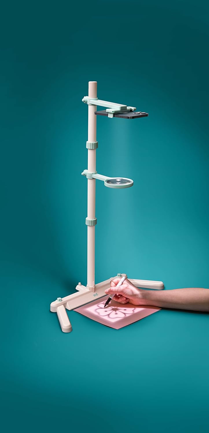 Lifestyle image of a person using the We R Makers Craft Projecter Tool for an art project.