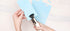 Lifestyle image of the We R Makers Crop-A-Dile Euro Hook Punch being used to punch holes in paper.