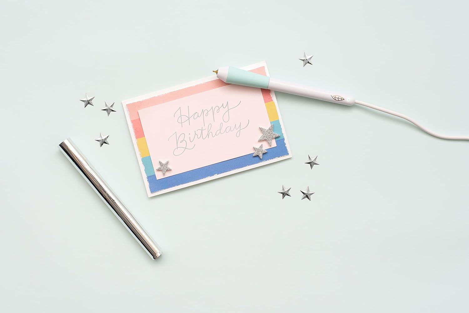 Picture of a card that says "Happy Birthday" written with a tool included in the We R Makers Foil Quill Freestyle Starter Kit.