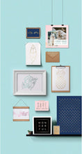 Load image into Gallery viewer, Lifestyle image of an assortment of foil crafts hanging on a wall
