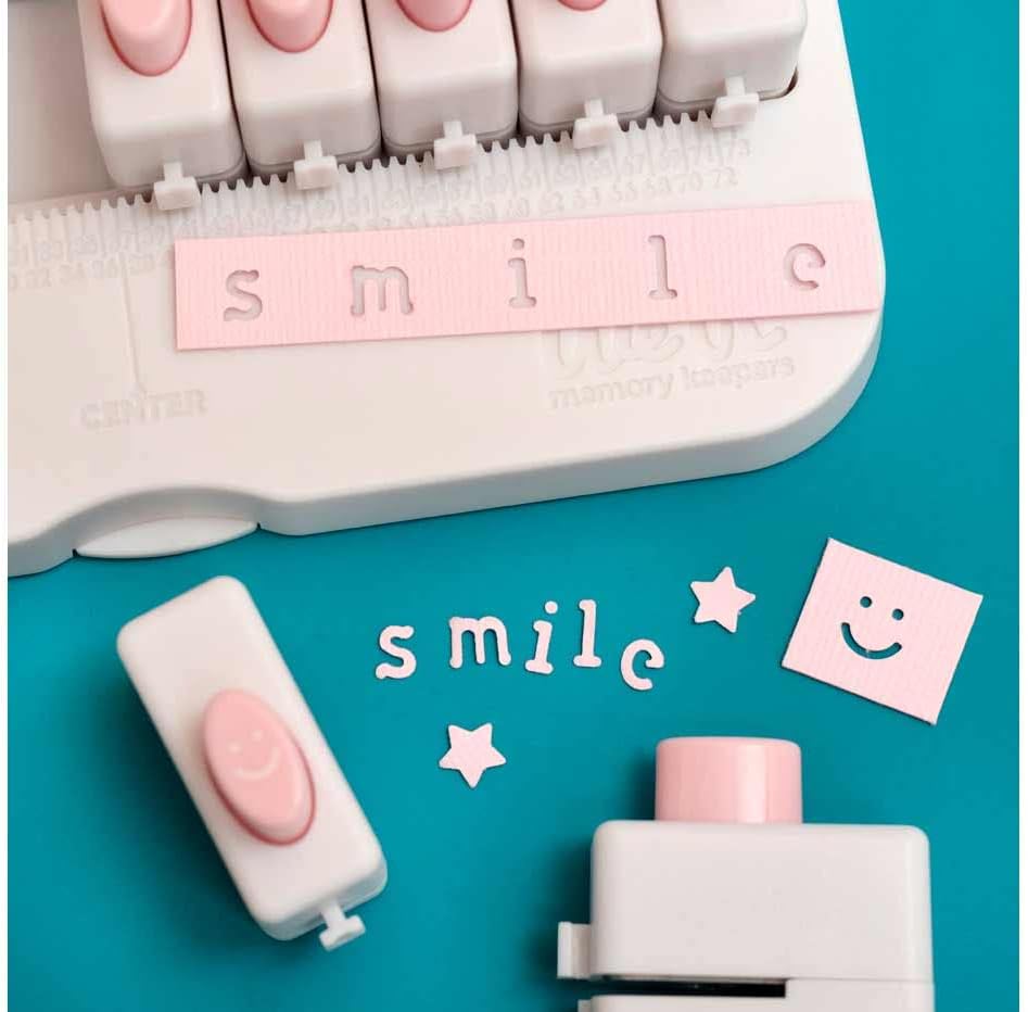Picture of the word "smile" punched out using the We R Makers Lower Case Alphabet Punch Board.