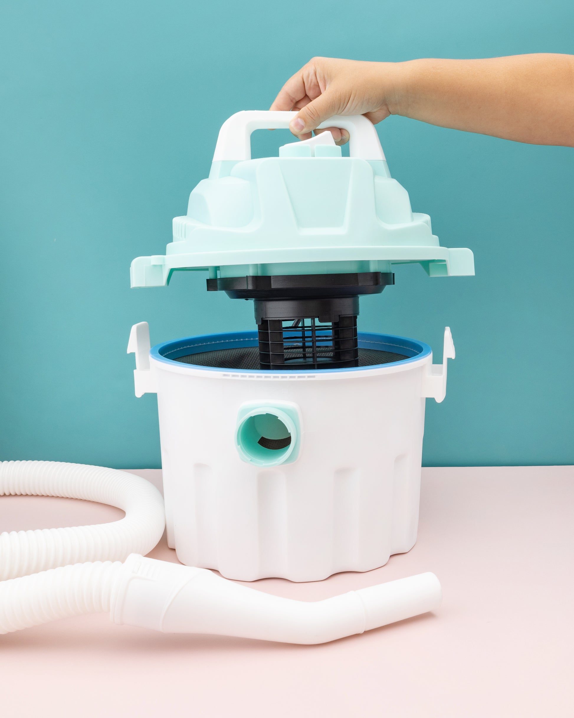 A picture of a person using the We R Makers Mold Press Wet/Dry Vacuum .