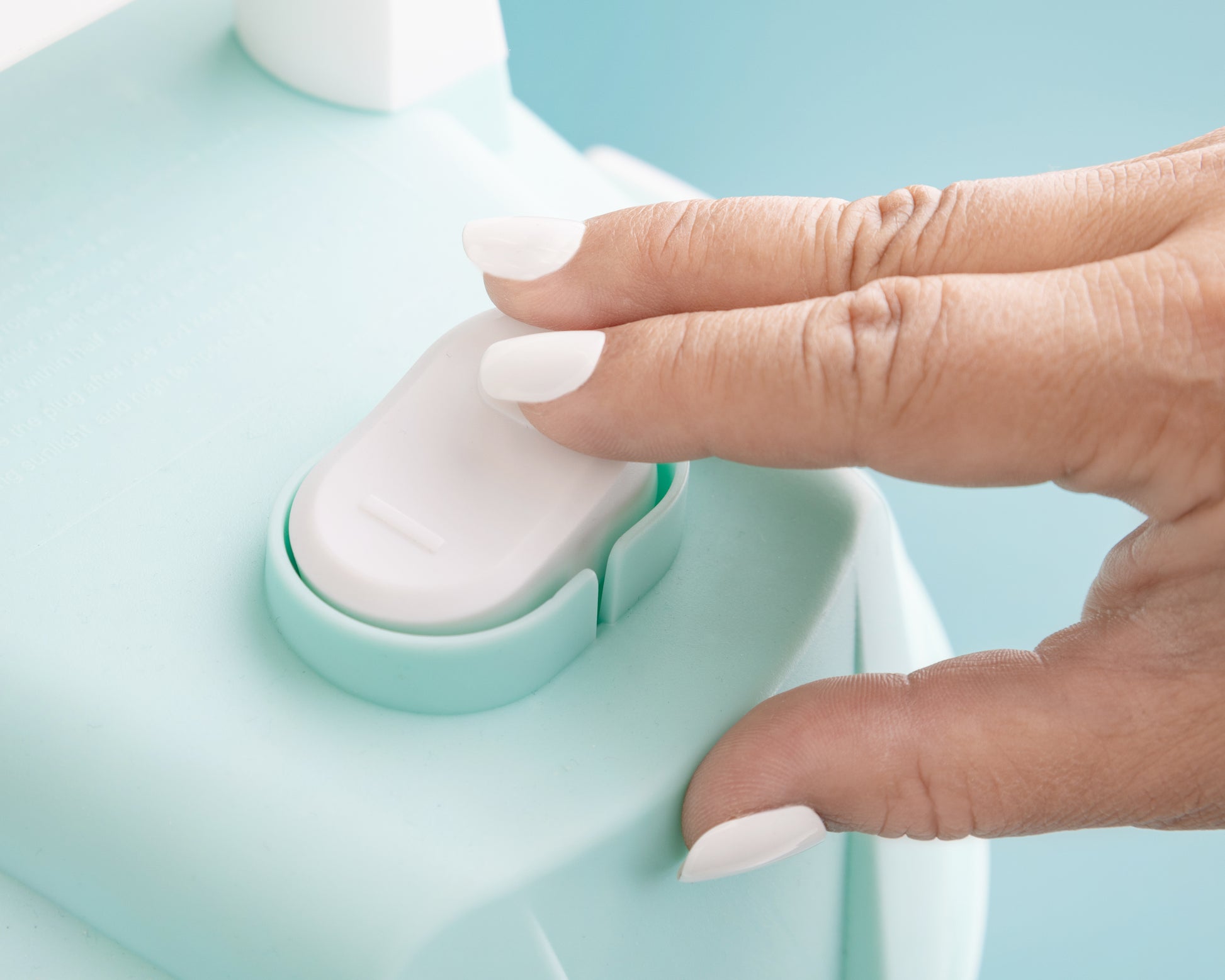 Picture of a person pressing a button on the We R Makers Mold Press Wet/Dry Vacuum.