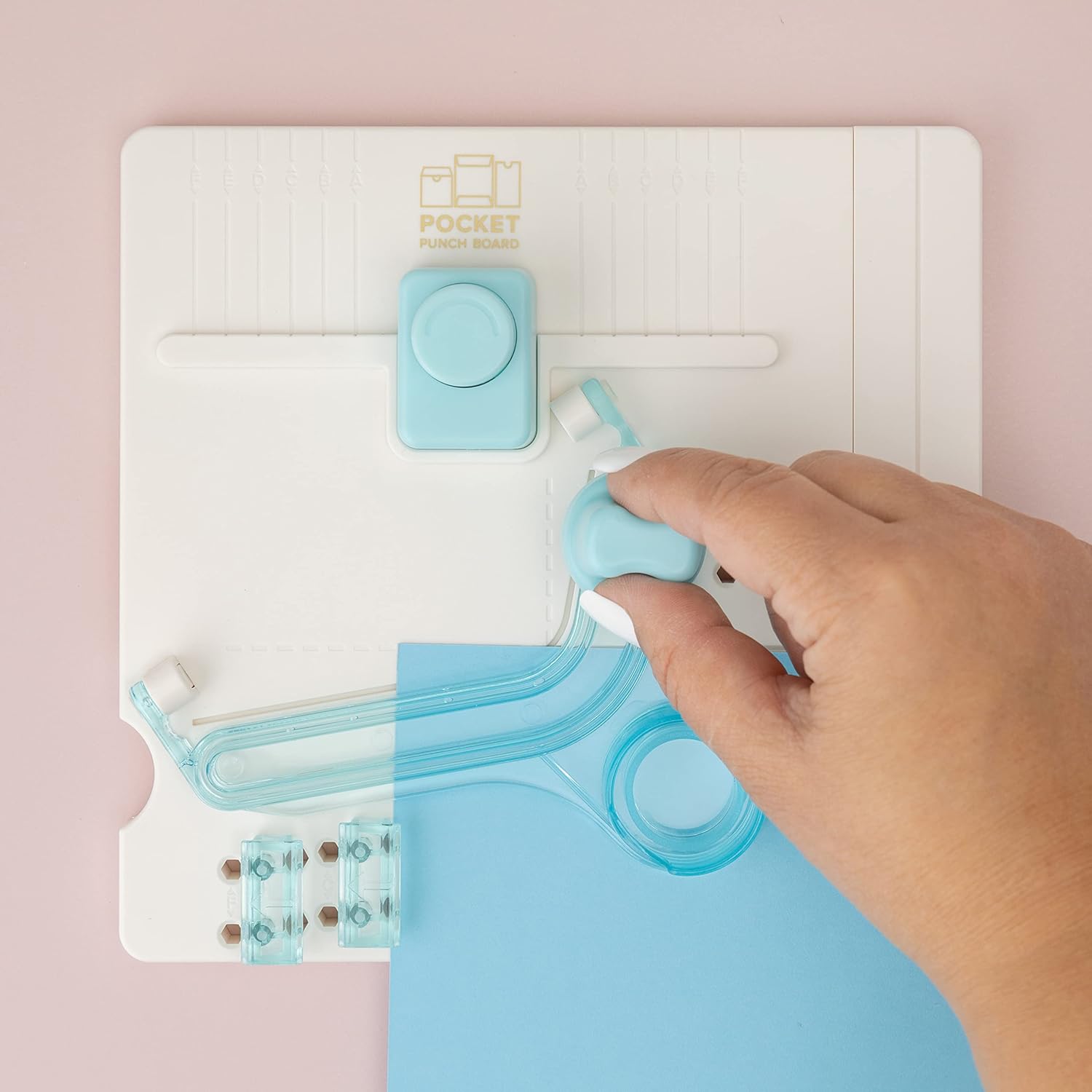 Image of a person using the We R Makers Pocket Maker Punch Board for a project.