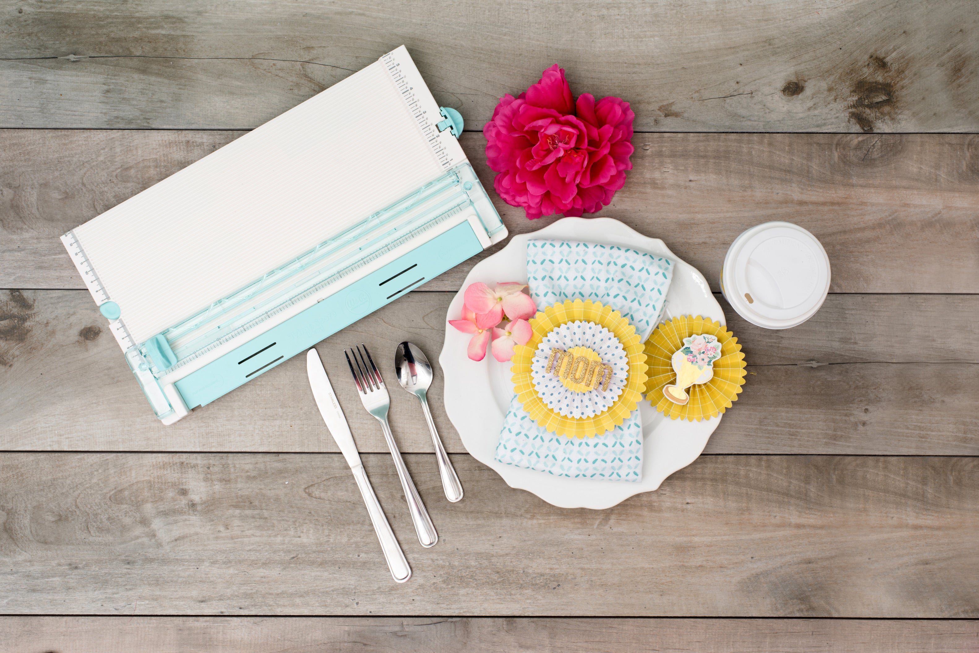 Lifestyle image of the We R Makers Trim & Score Board with One Blade next to an art project.