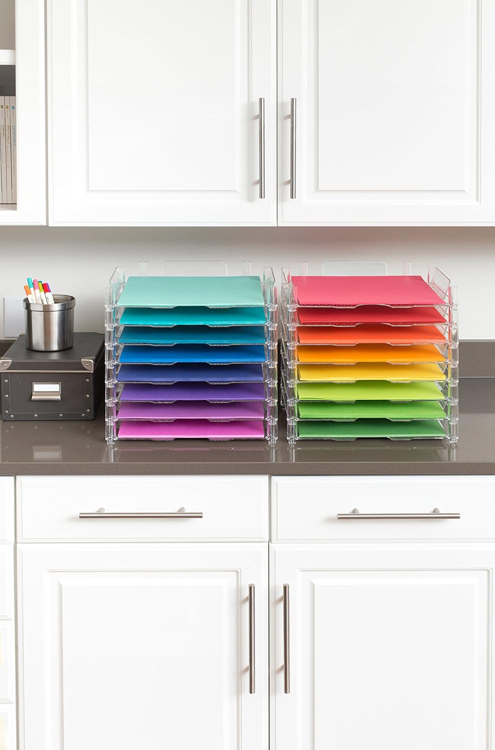 Image of the We R Makers 12x12 Paper Trays on a counter filled with colored paper.