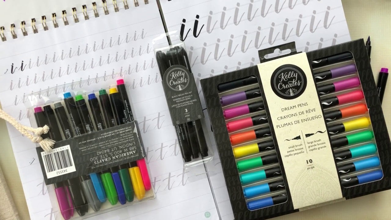 Load video: Take a look inside the new Kelly Creates workbooks with the trace &amp; learn system that will help you study the ‘bouncy’ playful style of brush lettering.